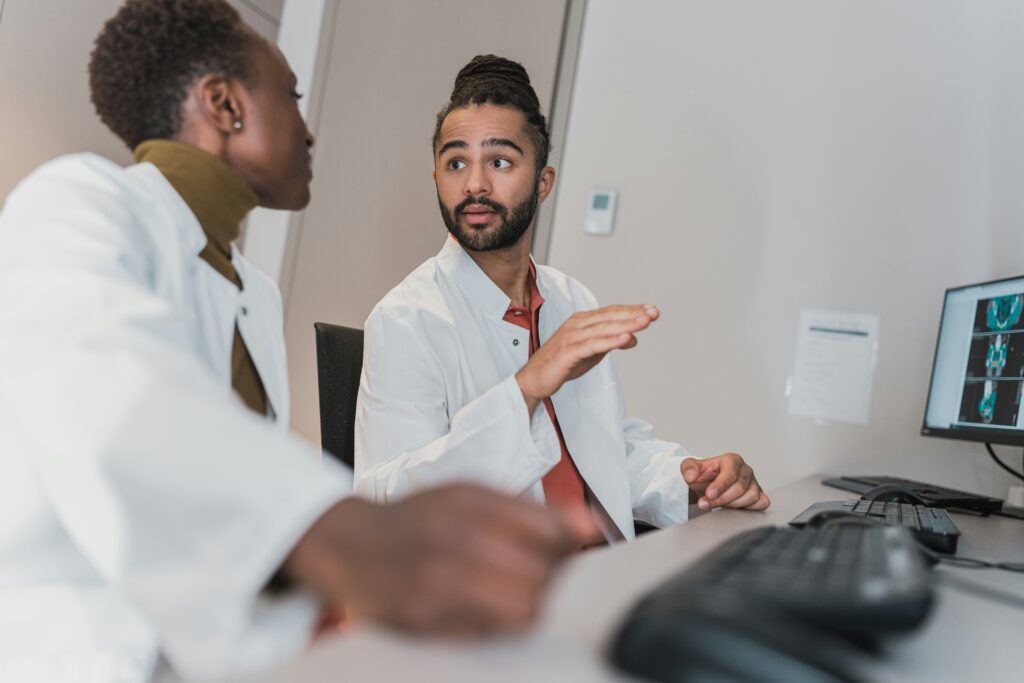 Two healthcare colleagues engage in a collaborative peer feedback discussion.