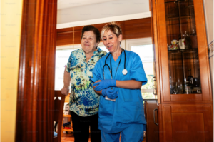 A nurse helping a patient to sit down